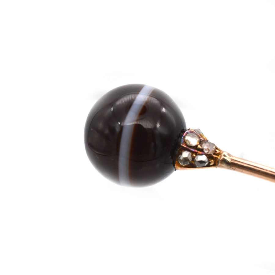 Victorian 15ct gold tie pin featuring a banded onyx sphere with diamond accents.