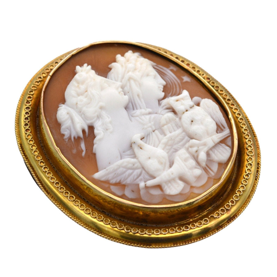 Victorian shell cameo brooch featuring allegorical figures of Day and Night, framed in gold.