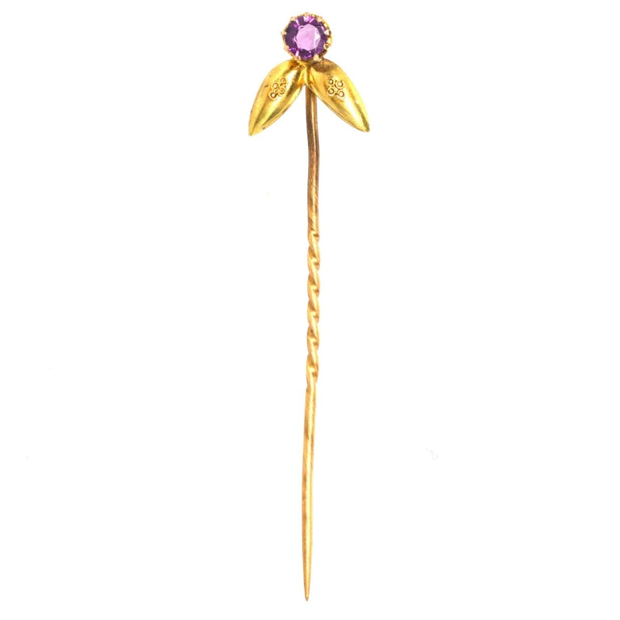 Victorian 15ct gold Etruscan Revival tie pin featuring an amethyst stone with floral design.