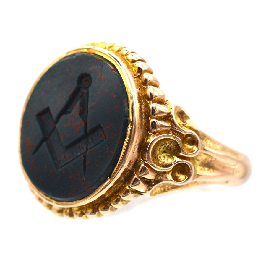 Victorian 15ct gold signet ring with bloodstone featuring Masonic emblem and ornate design.