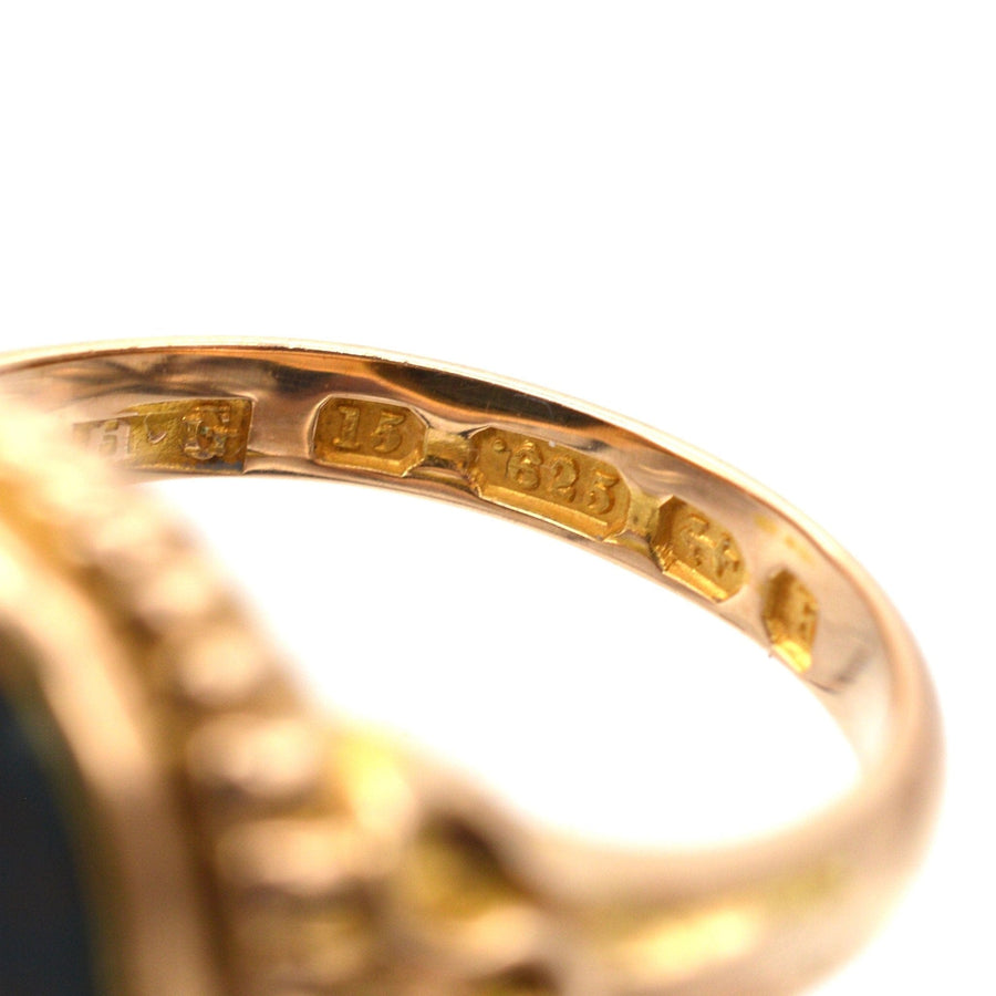 Close-up of the inner band of a Victorian 15ct gold signet ring showing Birmingham assay marks from 1866.