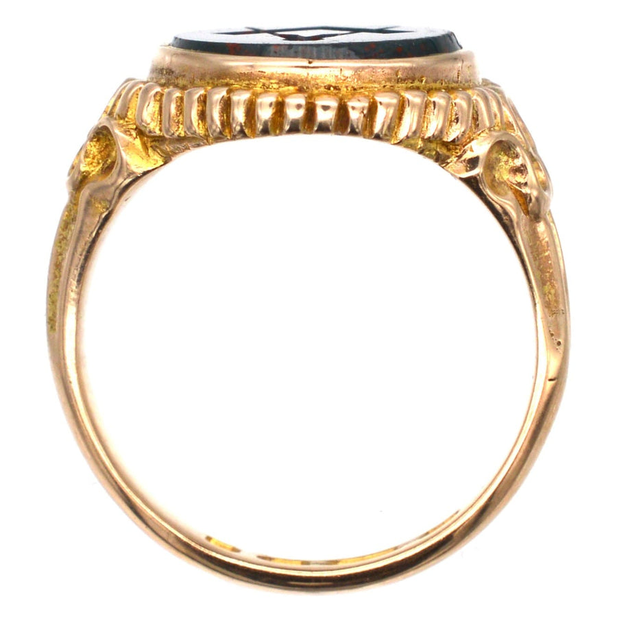 Side view of a Victorian 15ct gold Masonic signet ring featuring a bloodstone and decorative shoulders.
