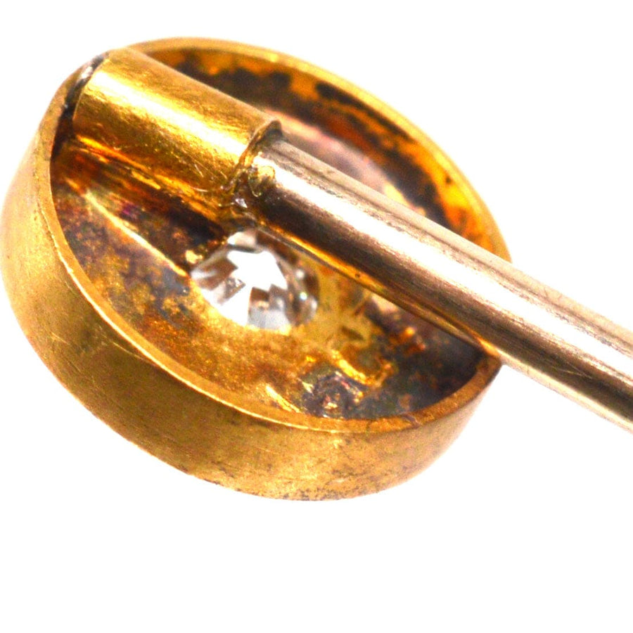 Close-up of a Victorian gold stickpin featuring an old mine cut diamond in a star-shaped setting.