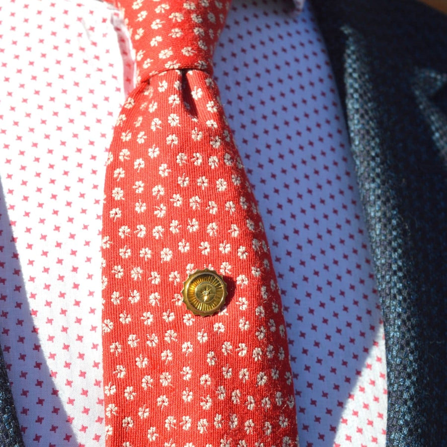 Victorian 15ct gold tie pin with rose diamond, worn on a patterned red tie and white shirt.