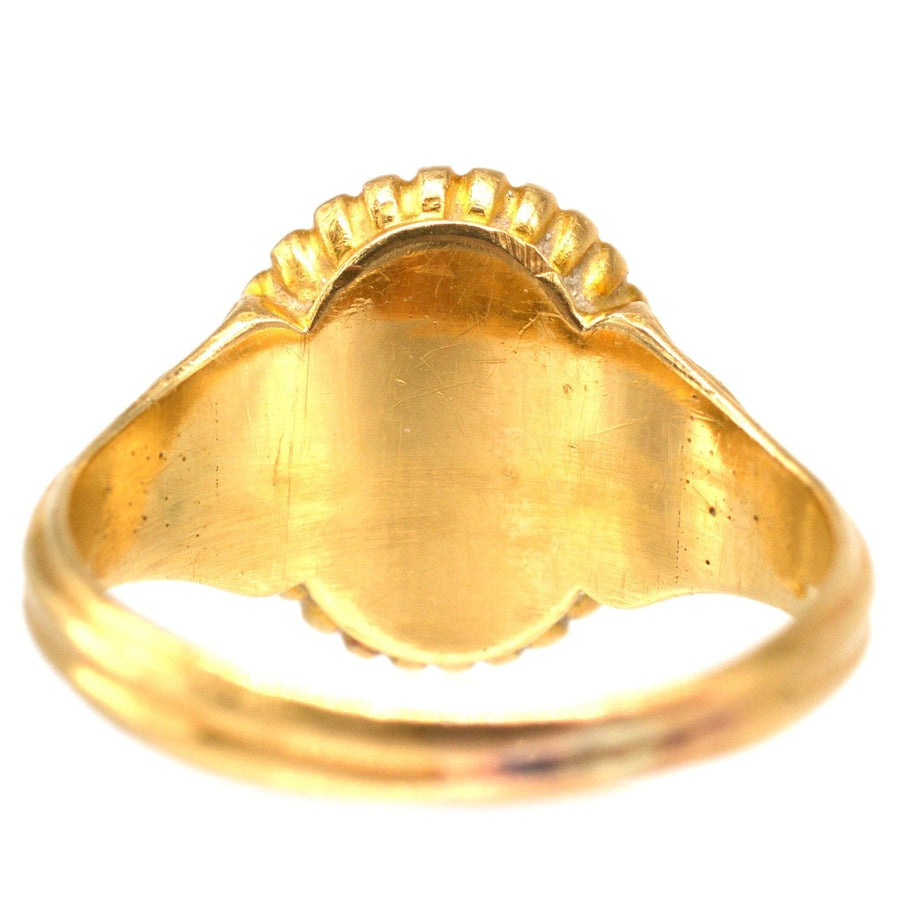 Back view of a Victorian 18ct gold bloodstone signet ring with decorated shoulders, showcasing fine craftsmanship.