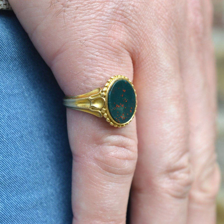 Victorian 18ct gold bloodstone signet ring worn on a hand, showcasing exquisite details and craftsmanship.