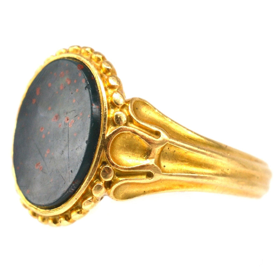 Victorian 18ct gold bloodstone signet ring featuring decorated shoulders, assayed in London 1858.