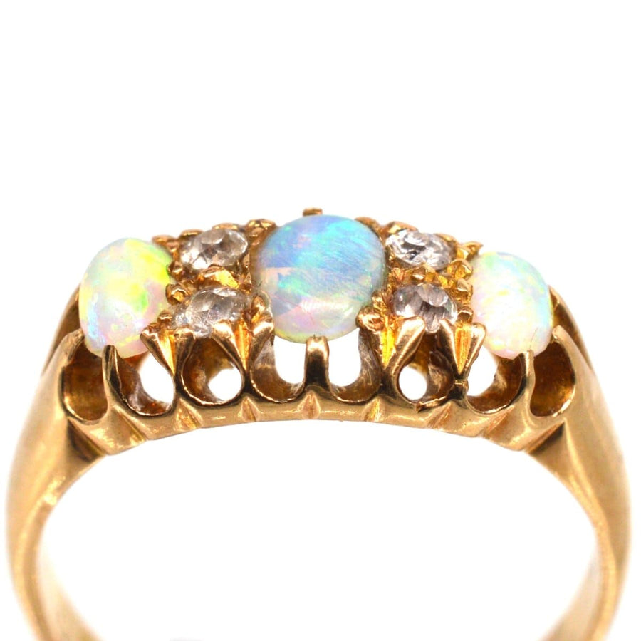 Victorian 18ct gold opal and diamond ring from 1875, featuring colorful opals and sparkling diamonds.