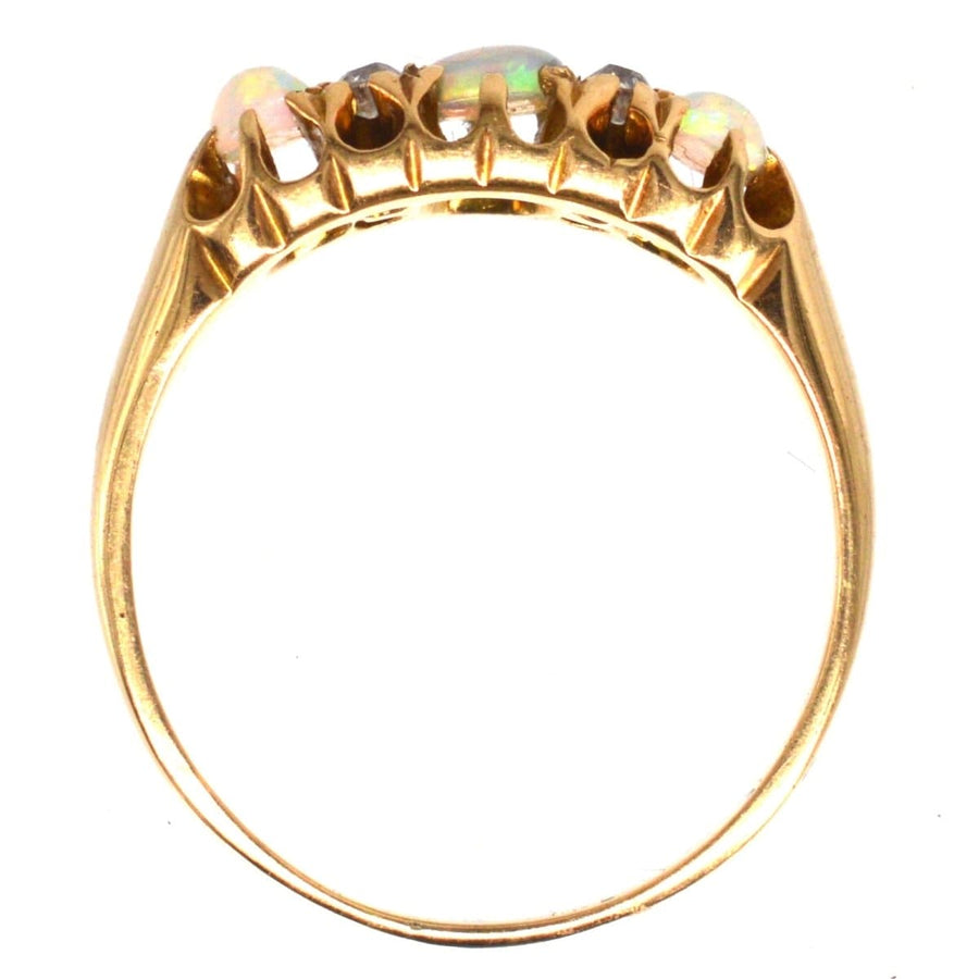 Victorian 18ct gold opal and diamond ring featuring colorful opals and sparkling diamonds, crafted in 1875.