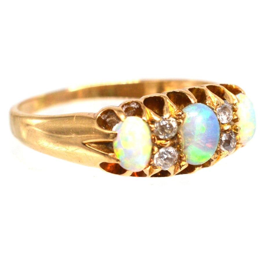 Victorian 18ct gold opal and diamond ring made in 1875, featuring colorful opals and sparkling diamonds.