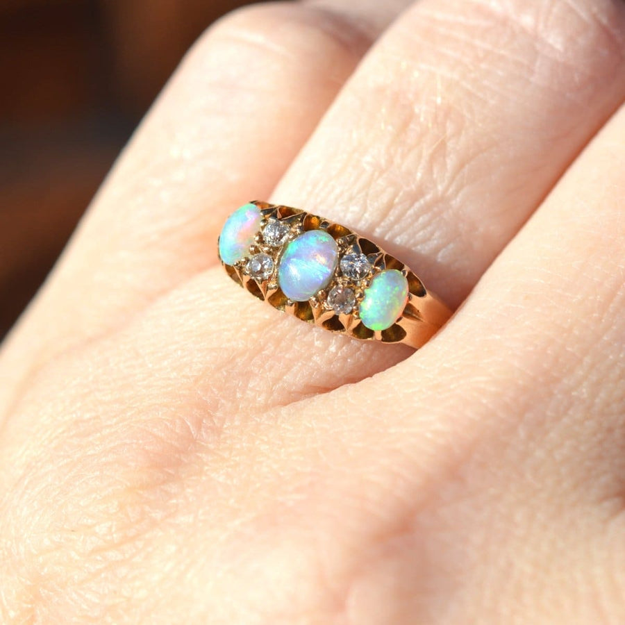 Victorian 18ct gold ring featuring colorful opals and diamonds, perfect for engagements and October birthdays.