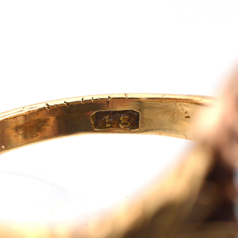 Close-up image of a Victorian gold ring showing its inner hallmark, indicating authenticity and age.
