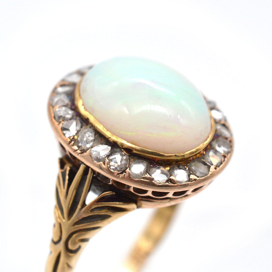 Victorian 18ct gold ring featuring a milky green opal surrounded by rose diamonds, dating back to the 1860s.