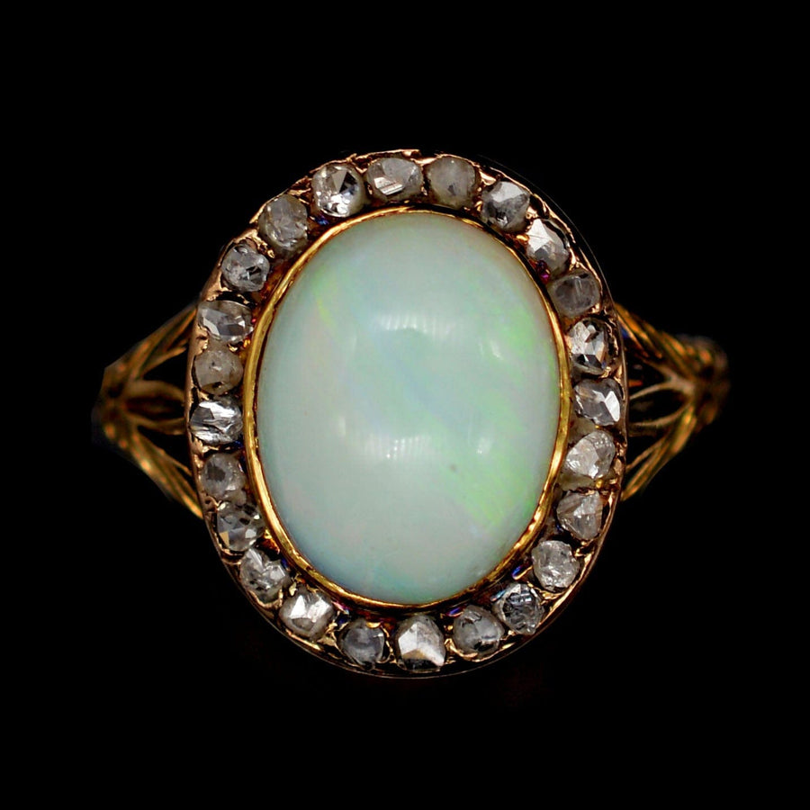 Victorian 18ct gold ring featuring a milky green opal and rose diamond cluster, elegant design from the 1860s.