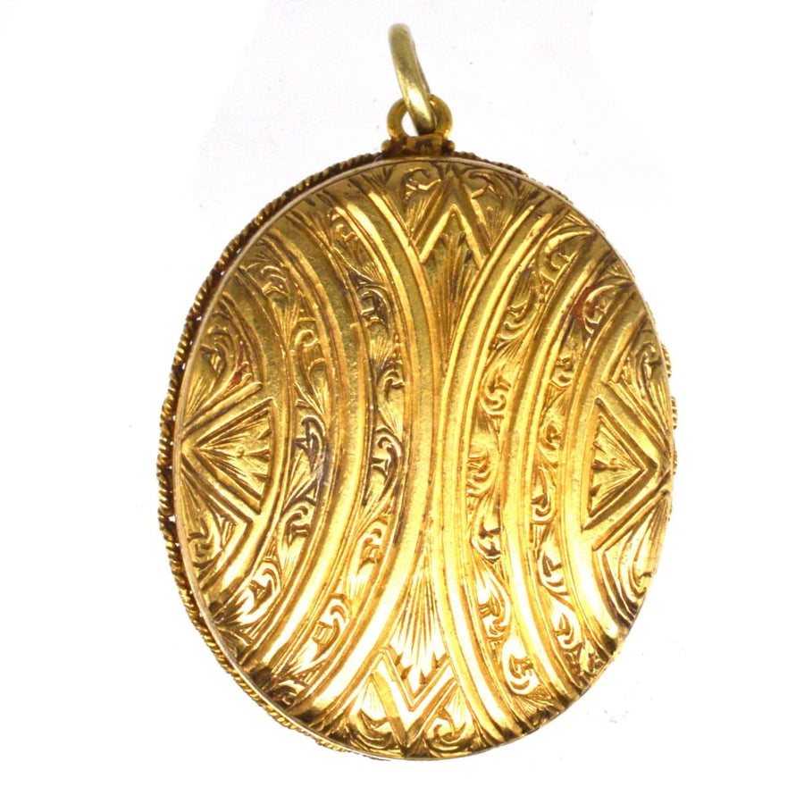 Victorian 18ct gold oval locket with intricate engraved design, a symbol of elegance and history.