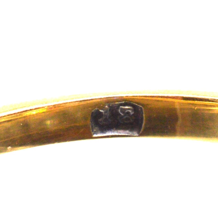 Close-up of the hallmark on a Victorian 2.2 Carat Diamond carved half hoop ring, indicating its authenticity.