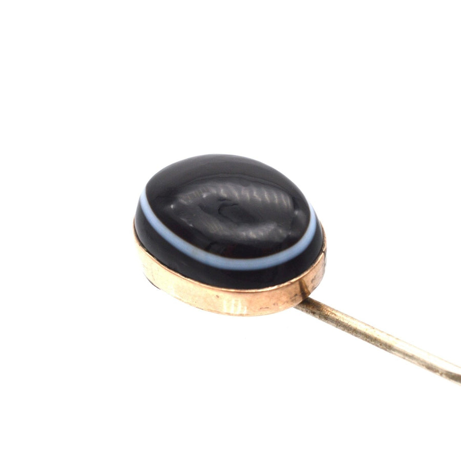 Victorian 9ct gold tie pin with large black onyx and blue band, showcasing intricate craftsmanship from the 1860s.