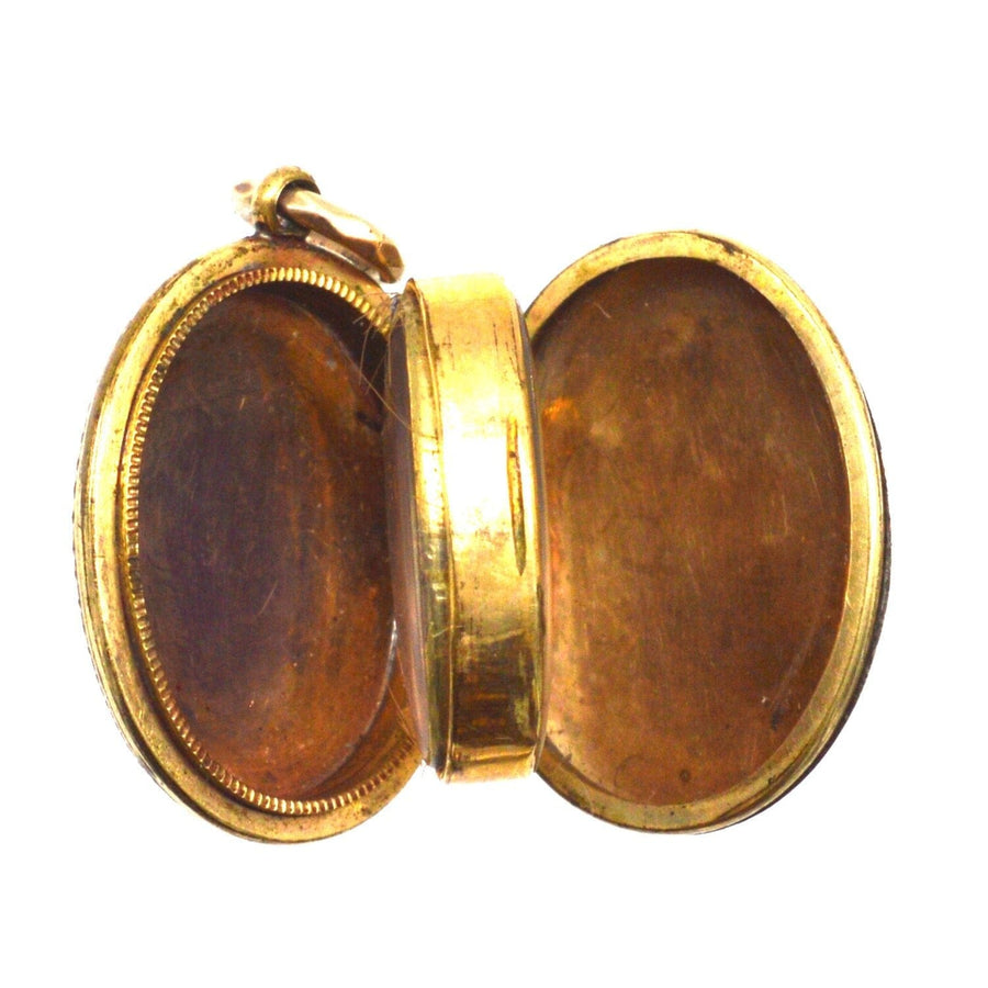 Interior view of a Victorian 9ct gold floral locket with two compartments, showcasing elegant design and vintage charm.