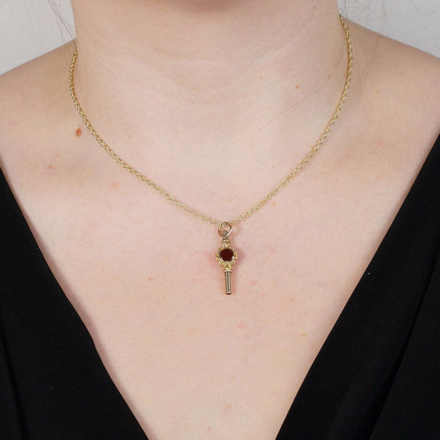 Victorian gold cased watch key pendant featuring bloodstone and cornelian stones on a delicate chain.