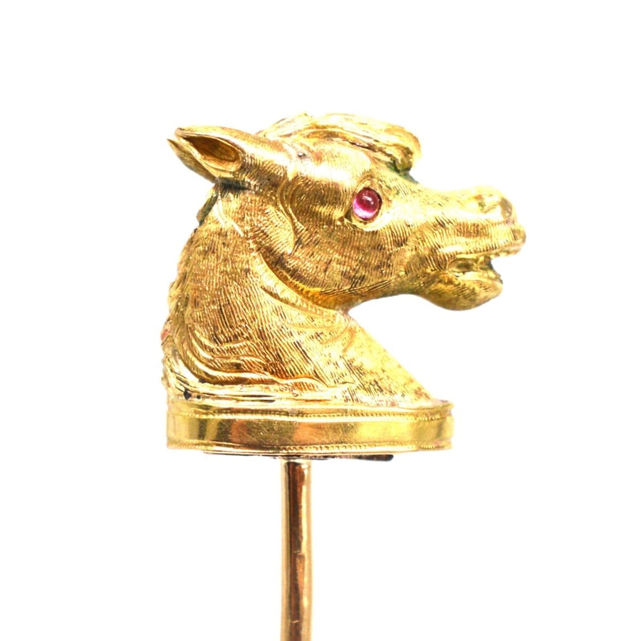 Victorian Scottish 18ct gold horse head tie pin with ruby eyes and garter belt detail.