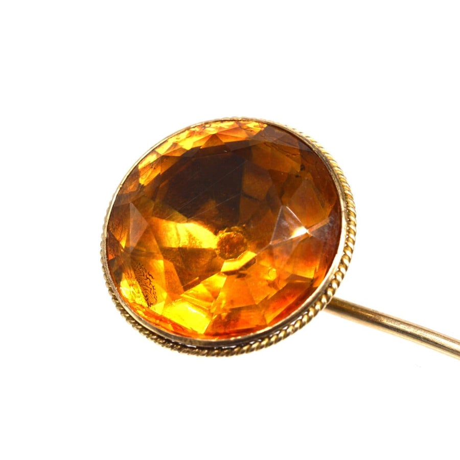 Close-up of a Victorian 9ct gold tie pin featuring a large faceted Cairngorm Citrine gemstone, circa 1870s.