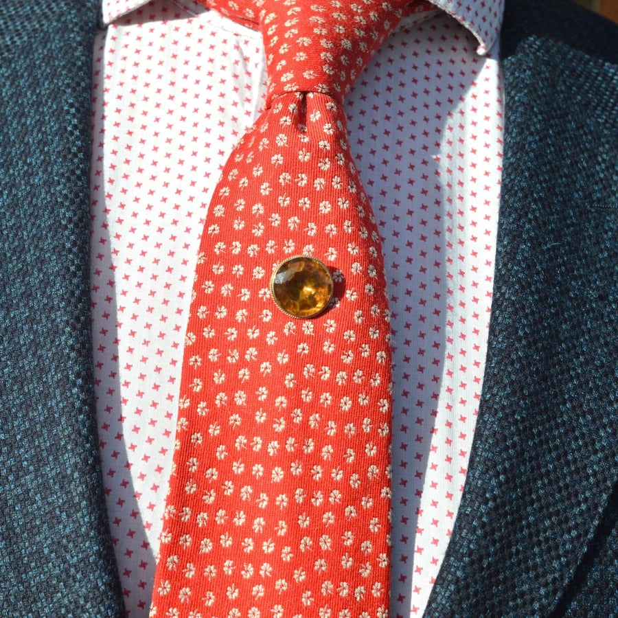 Victorian 9ct gold tie pin with large Cairngorm Citrine, worn on a patterned red tie and white shirt.