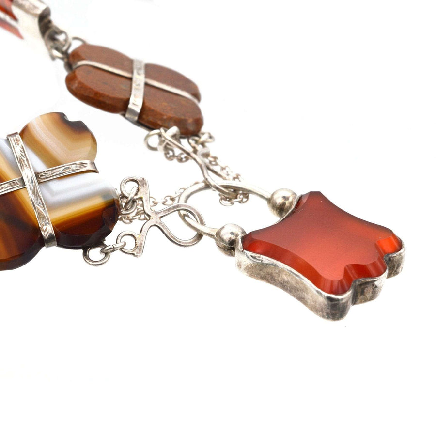 Close-up of Victorian Scottish silver and agate bracelet with carnelian and banded agate stones, showcasing intricate details.