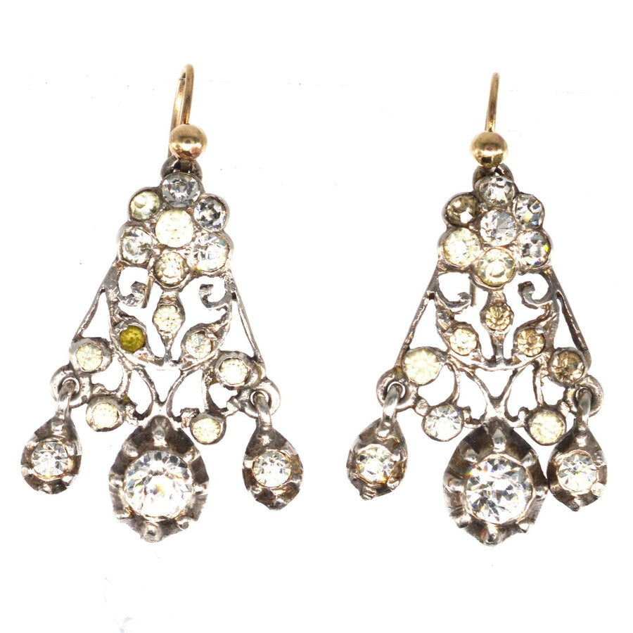 Victorian silver paste chandelier earrings with intricate fretwork and sparkling stones.