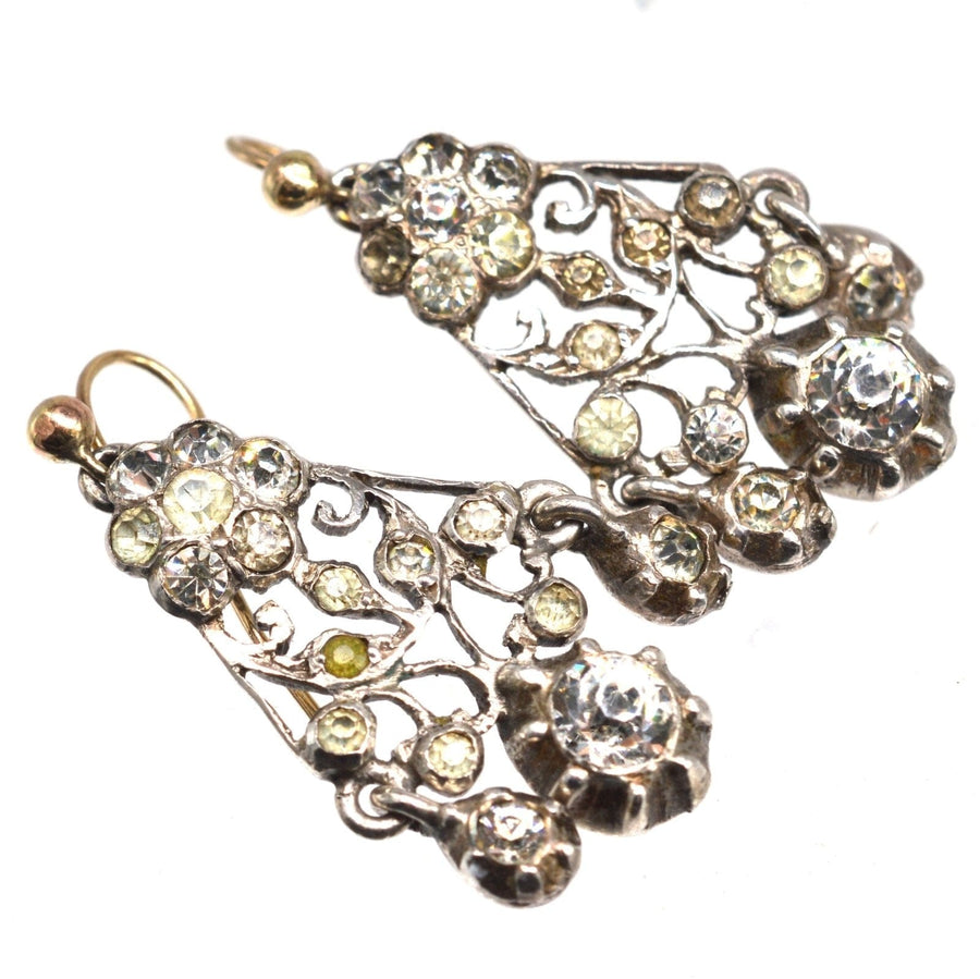 Antique Victorian silver paste chandelier earrings with floral design and sparkling crystals.