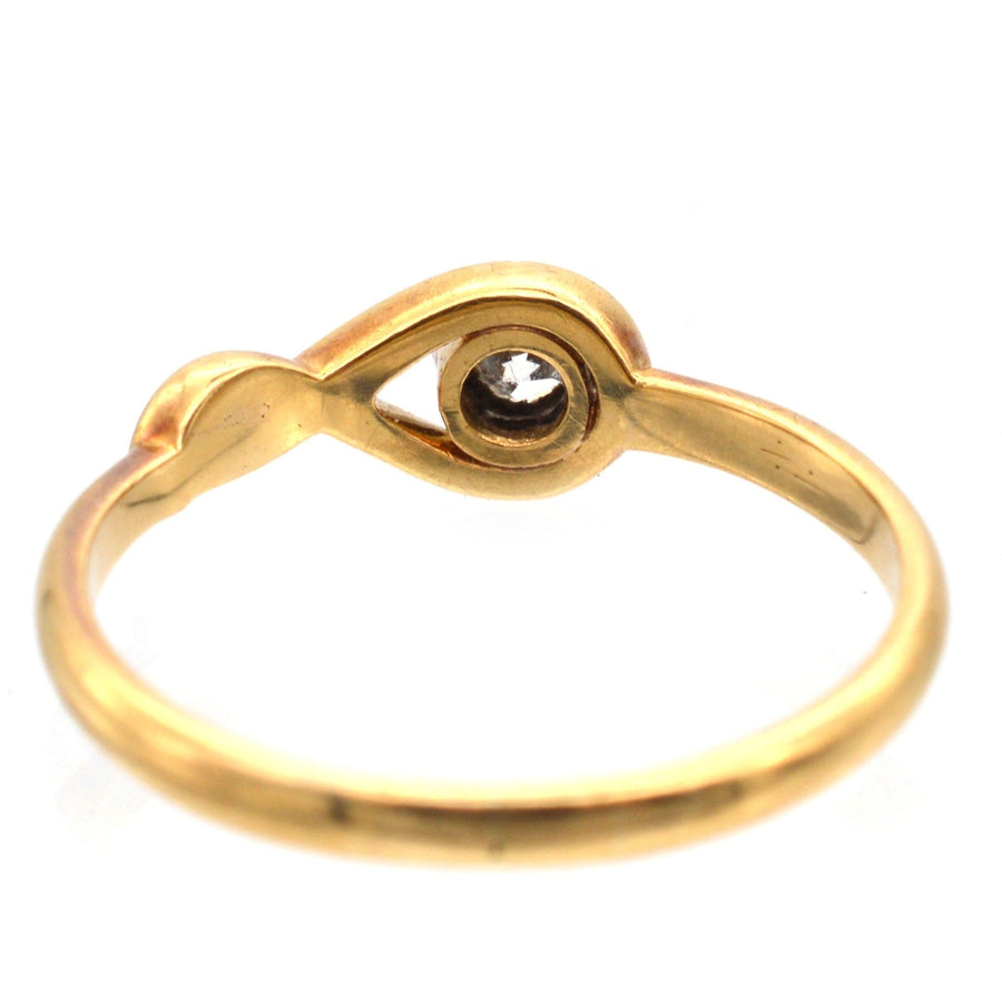 Vintage 18ct gold ring featuring a bezel-set diamond, elegant design perfect for engagement.