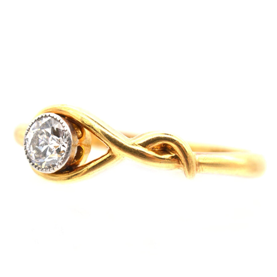 Vintage 18ct gold ring with a bezel-set 0.20 carat diamond in a sinuous design, ideal for engagement.