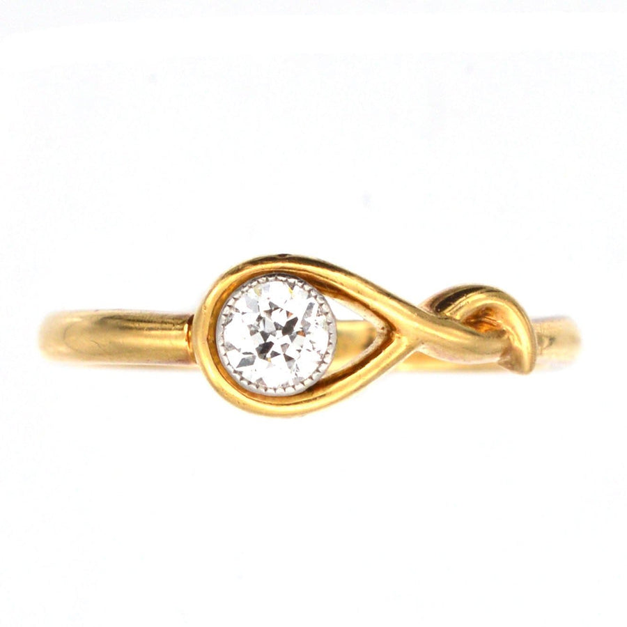 Vintage 18ct gold diamond bezel set solitaire ring with a unique sinuous design.