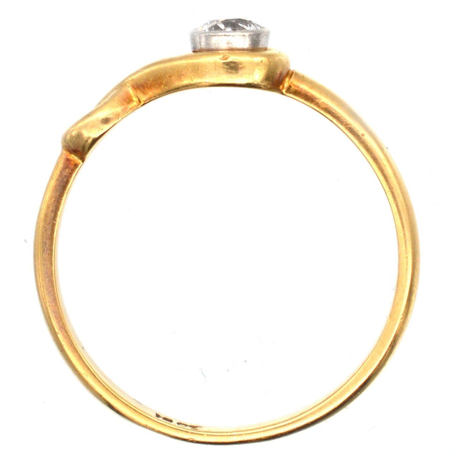 Vintage 18ct gold solitaire ring with bezel-set 0.20 carat diamond, elegant sinuous design for engagement.