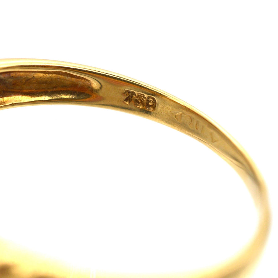 Detail shot of vintage 18ct gold ring's inner band with hallmark and inscription.