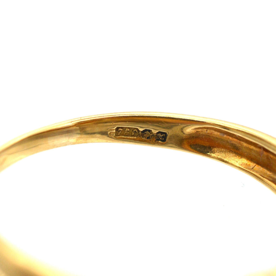 Close-up of the interior hallmark of a vintage 18ct gold ring, showcasing the detailed craftsmanship.
