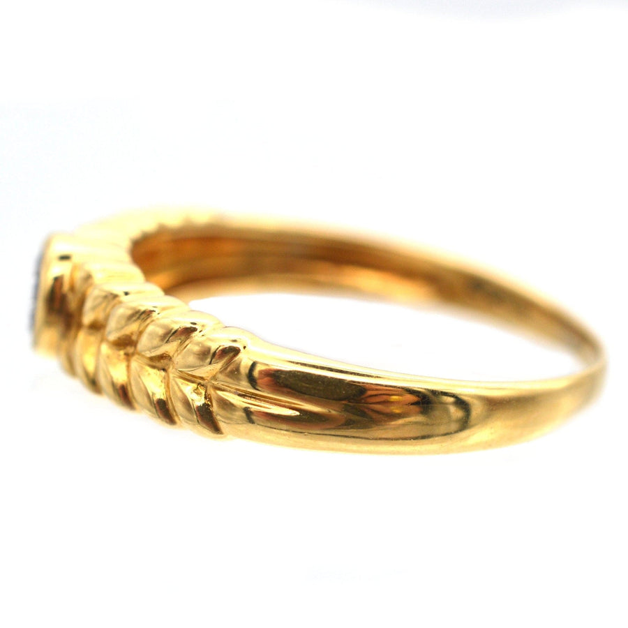 Vintage 18ct gold diamond solitaire ring with laurel wreath shoulders, side view showcasing intricate design.