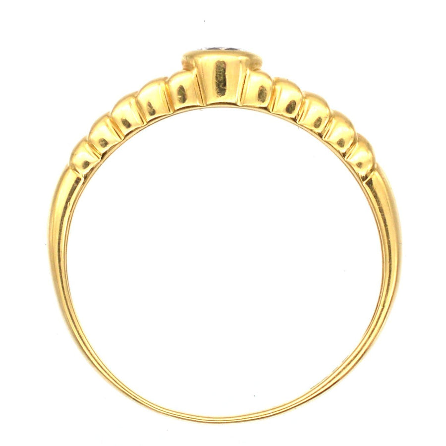 Vintage 18ct gold diamond solitaire ring with laurel wreath shoulders, featuring a 0.20 carat bright white diamond.