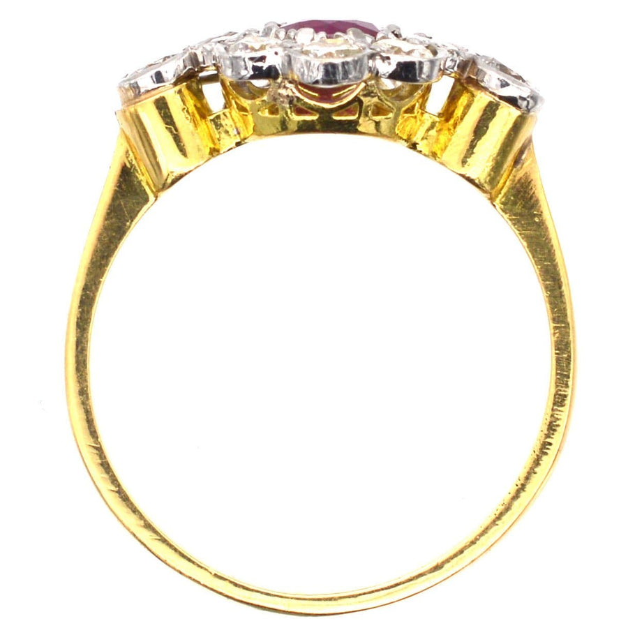 Vintage 18ct gold and platinum ruby and diamond cluster ring, featuring a natural ruby and sparkling white diamonds.