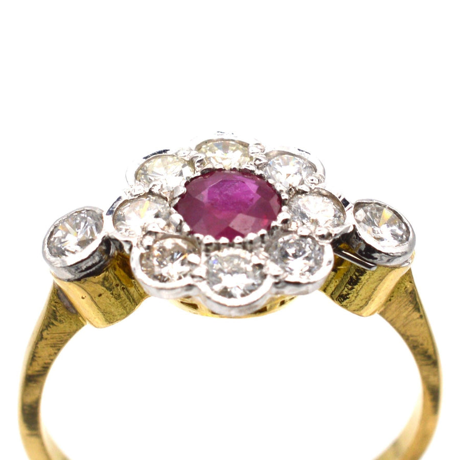 Vintage 18ct gold and platinum ruby and diamond cluster ring with a natural ruby centerpiece.