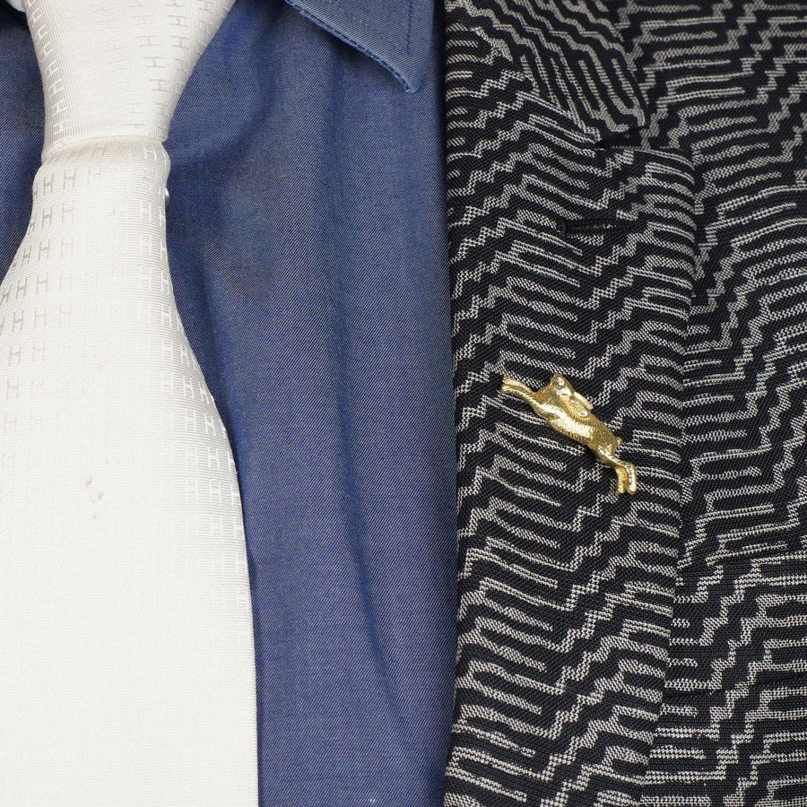 Vintage 18ct gold rabbit brooch with diamond eye on a lapel, perfect for adding playful charm to attire.