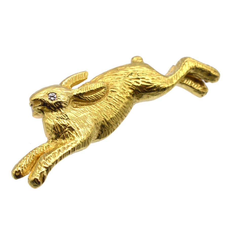 Vintage 18ct gold rabbit brooch with diamond eye, playfully leaping, perfect for lapel or tie.