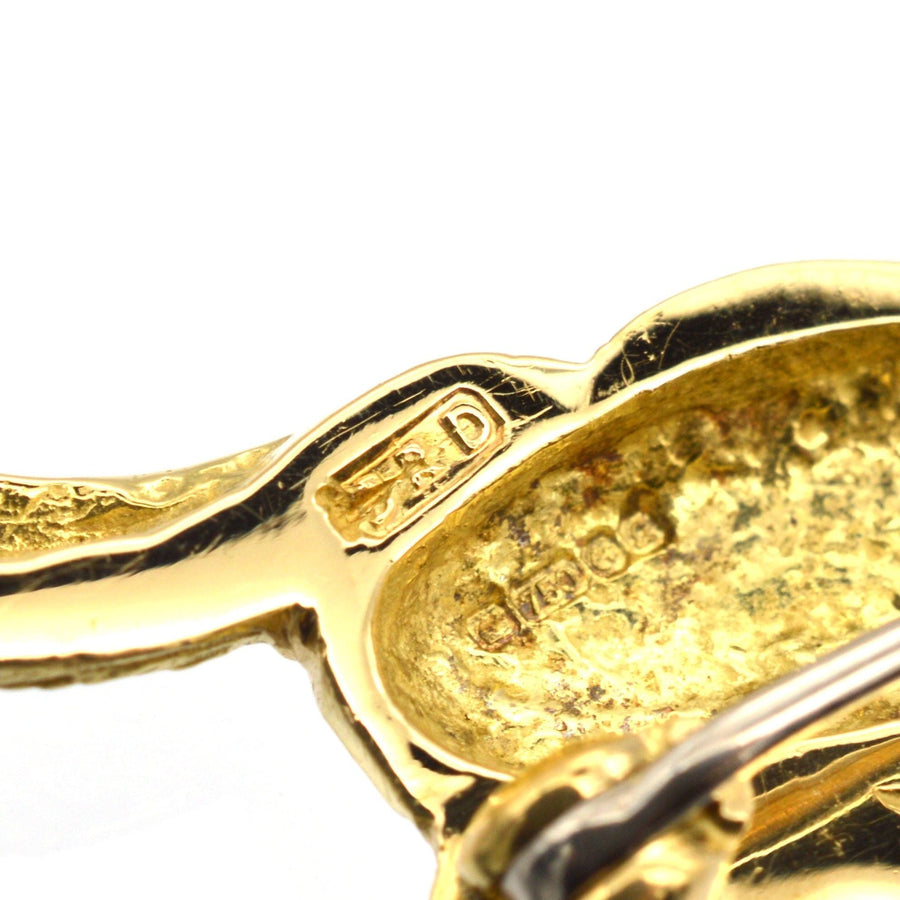 Close-up of vintage 18ct gold rabbit brooch showing craftsmanship and hallmark details.