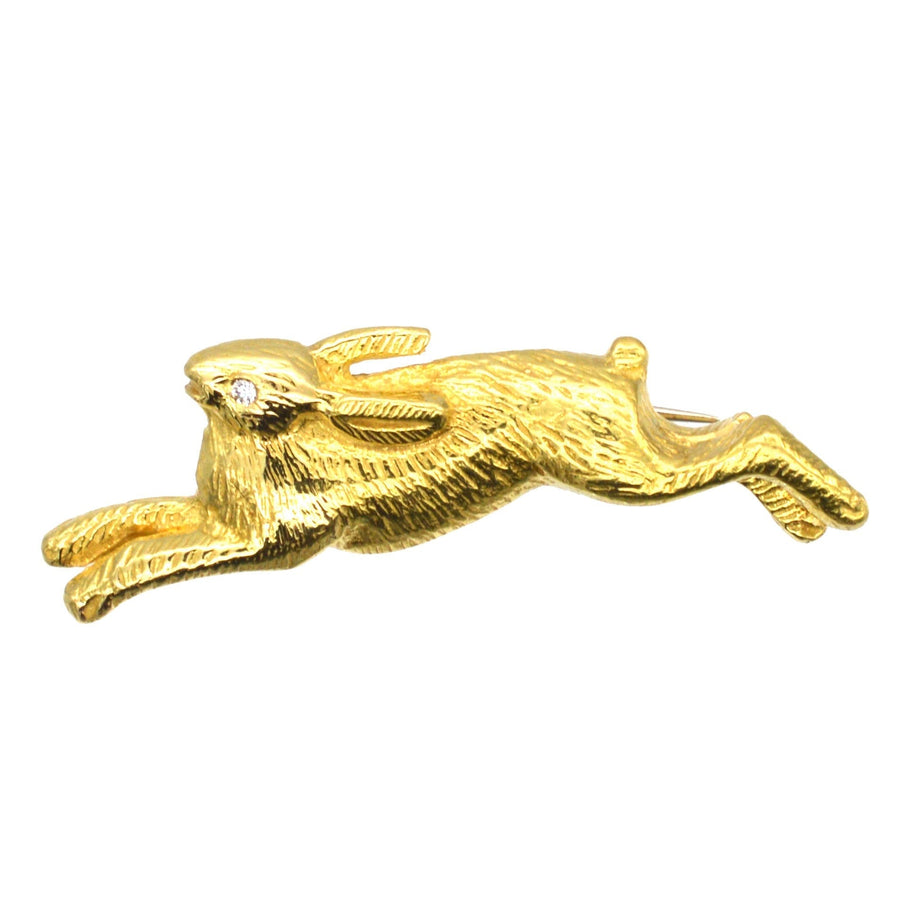 Vintage 18ct gold brooch of a playful running rabbit with a diamond eye, crafted in 1985.