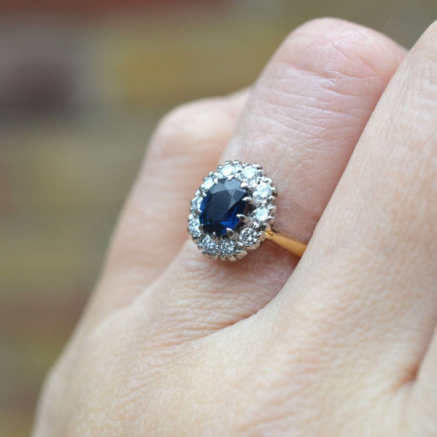 Vintage 18ct Gold Sapphire and Diamond Oval Cluster Ring worn on hand, showcasing its elegant design and cluster setting.