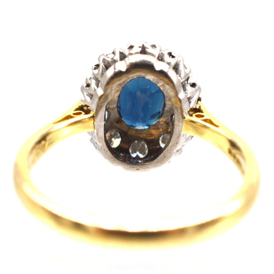 Vintage 18ct gold sapphire and diamond oval cluster ring, featuring a stunning blue sapphire and sparkling diamonds.
