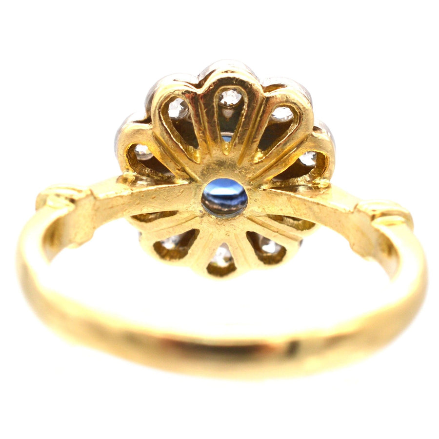 Vintage 18ct gold cluster ring featuring sapphire and diamond, beautifully crafted with a unique floral design.
