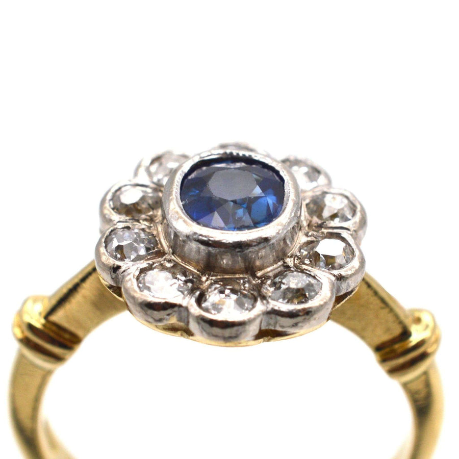 Vintage 18ct gold cluster ring featuring a sapphire center and diamonds, perfect for an engagement or special occasion.