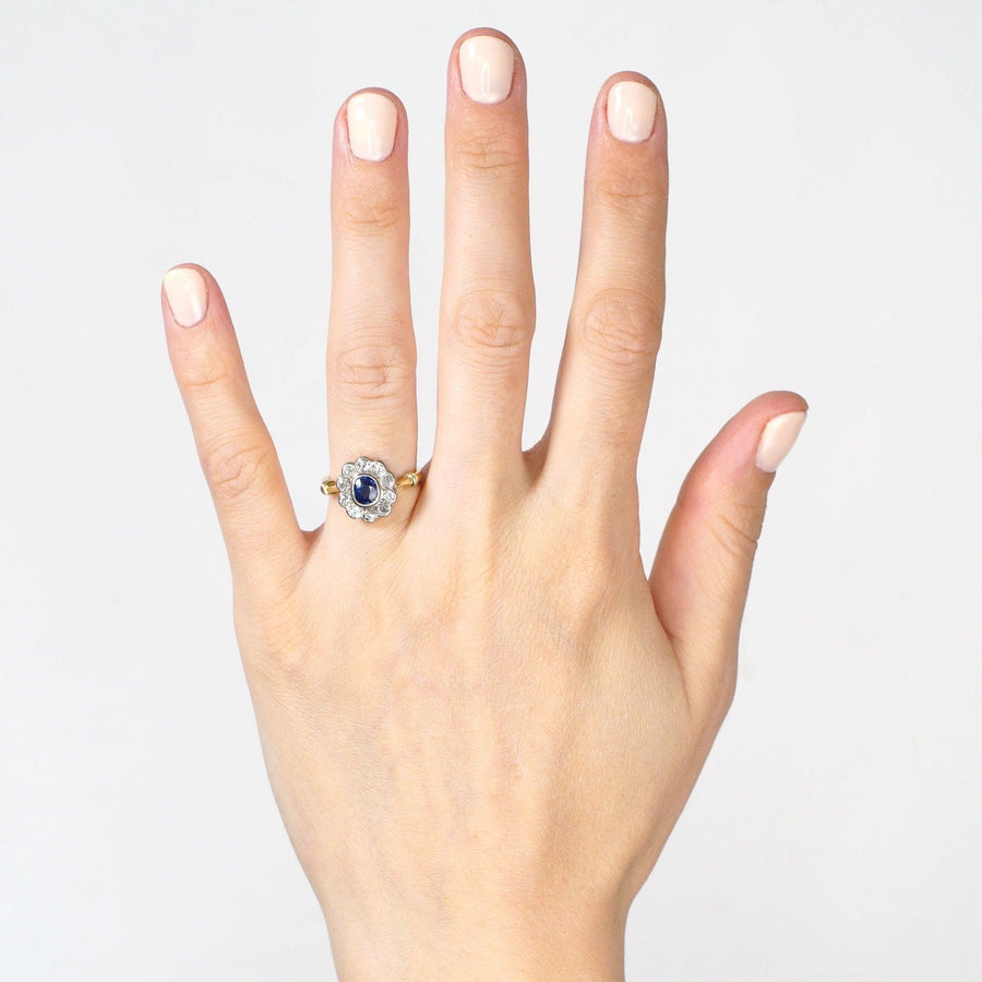 Vintage 18ct gold sapphire and diamond cluster ring displayed on a hand, perfect for engagement or special occasions.