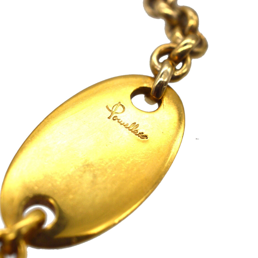 Close-up of the Pomellato engraved name tag on a vintage 18ct gold trace link chain necklace.
