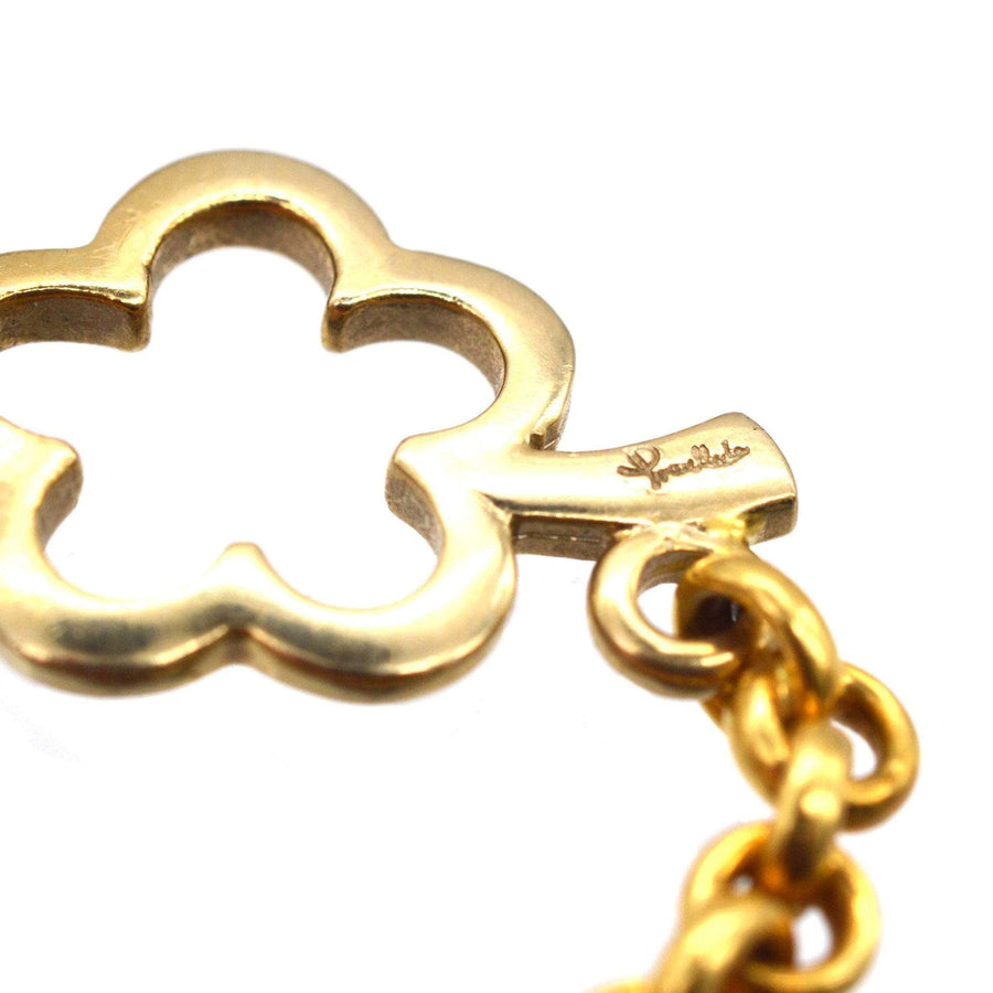 Close-up of Pomellato vintage gold chain link with a four-leaf clover pendant detail, showcasing its intricate design.